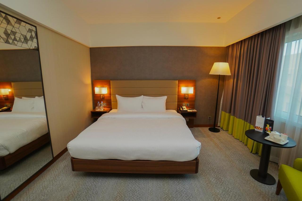 The Grand Lux Hotel Ad Dawhah Esterno foto A room at the hotel