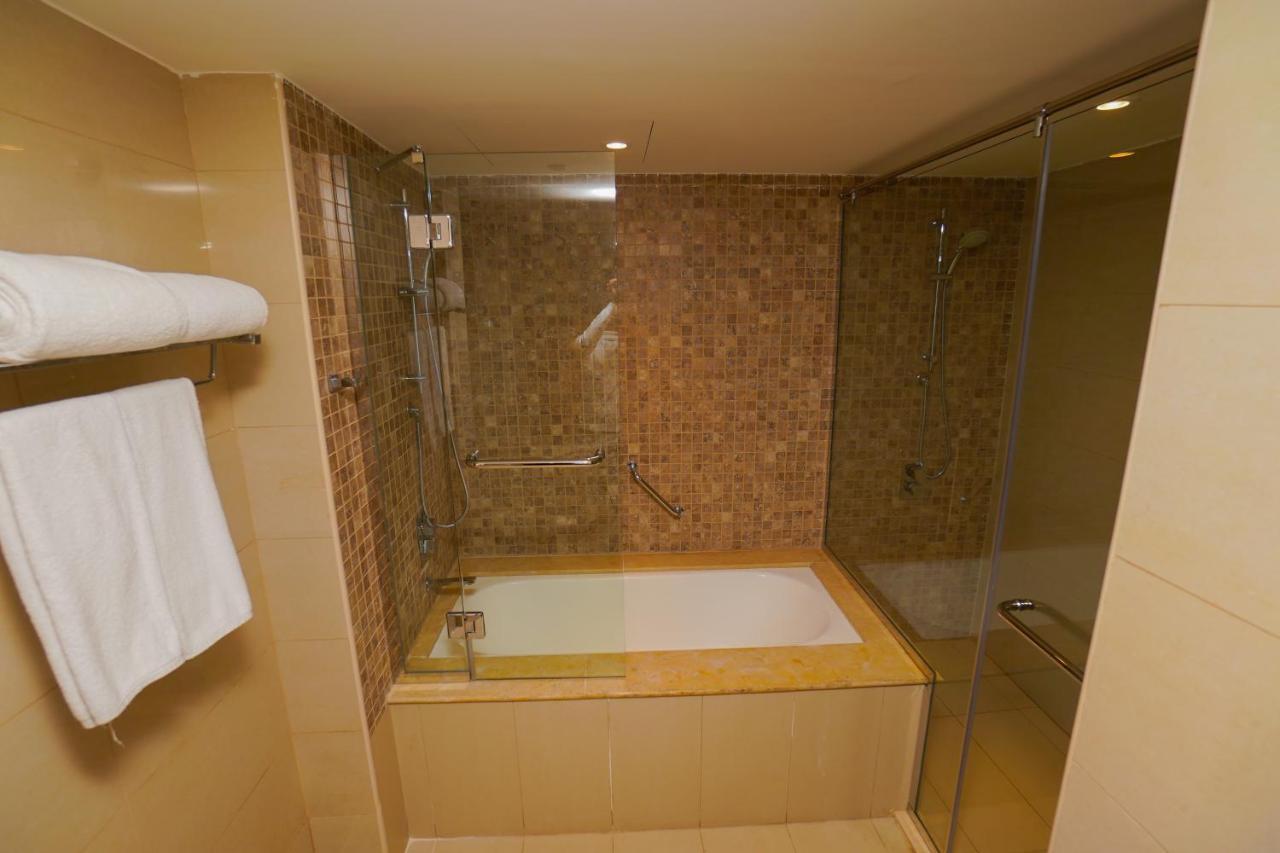 The Grand Lux Hotel Ad Dawhah Esterno foto A bathtub with a shower enclosure