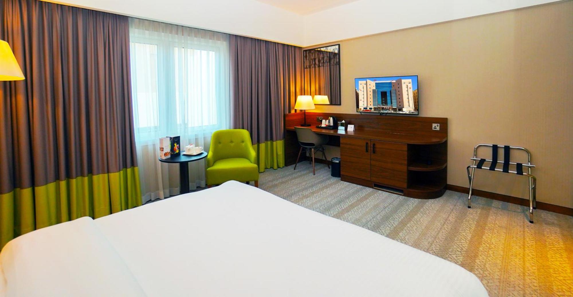 The Grand Lux Hotel Ad Dawhah Esterno foto A room at the hotel